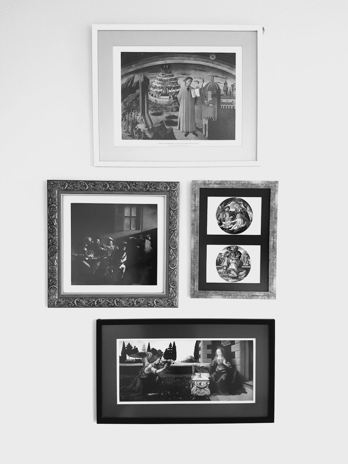 Gallery wall with four framed art prints on a white wall