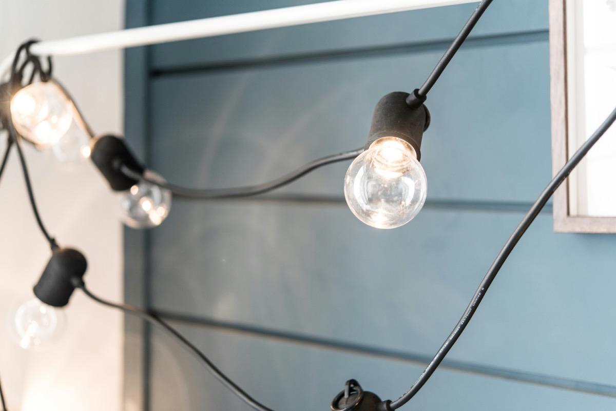 Close-up of warm glowing string lights with clear bulbs