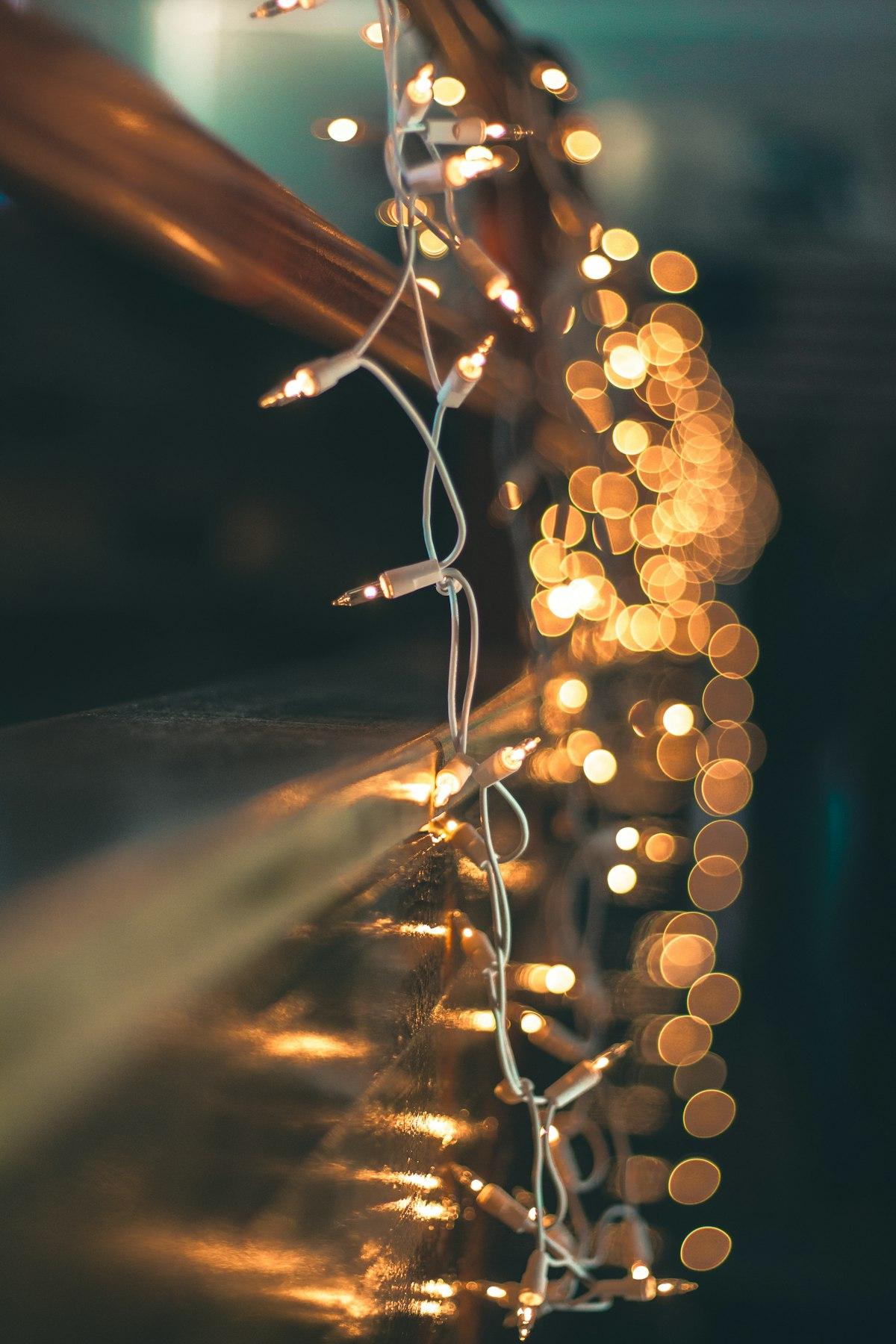 Warm glowing mini string lights draped along an edge
