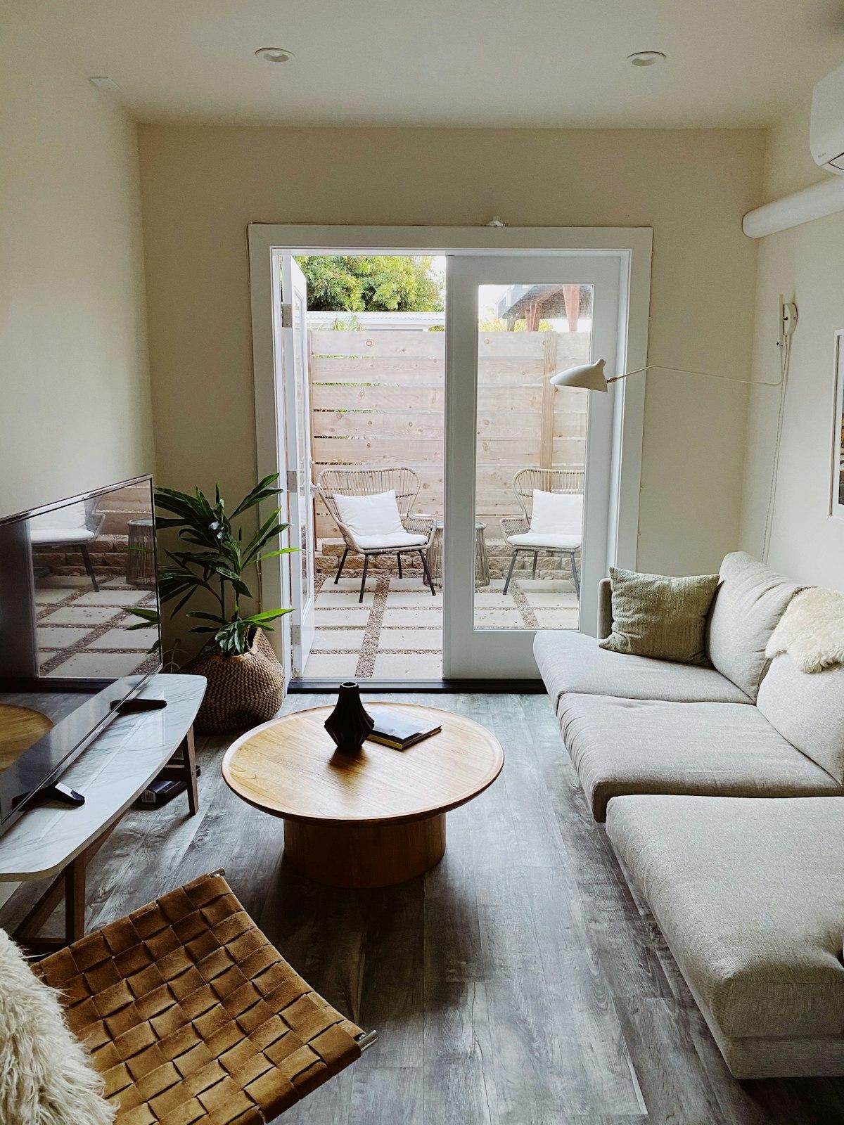 Round light wood coffee table in a bright living room